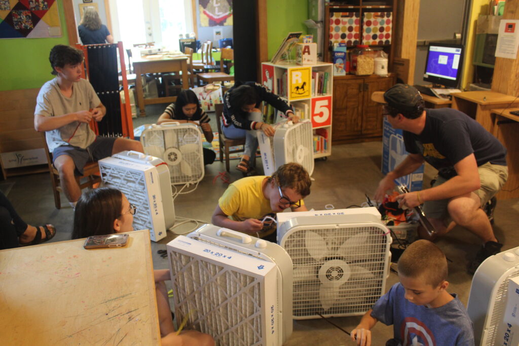 A group of Millvale Cohort teens making low-cost DIY fan filters 