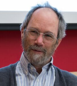 Photo of Don Fugler, a middle-aged white man with a collared shirt, a beard, and glasses.
