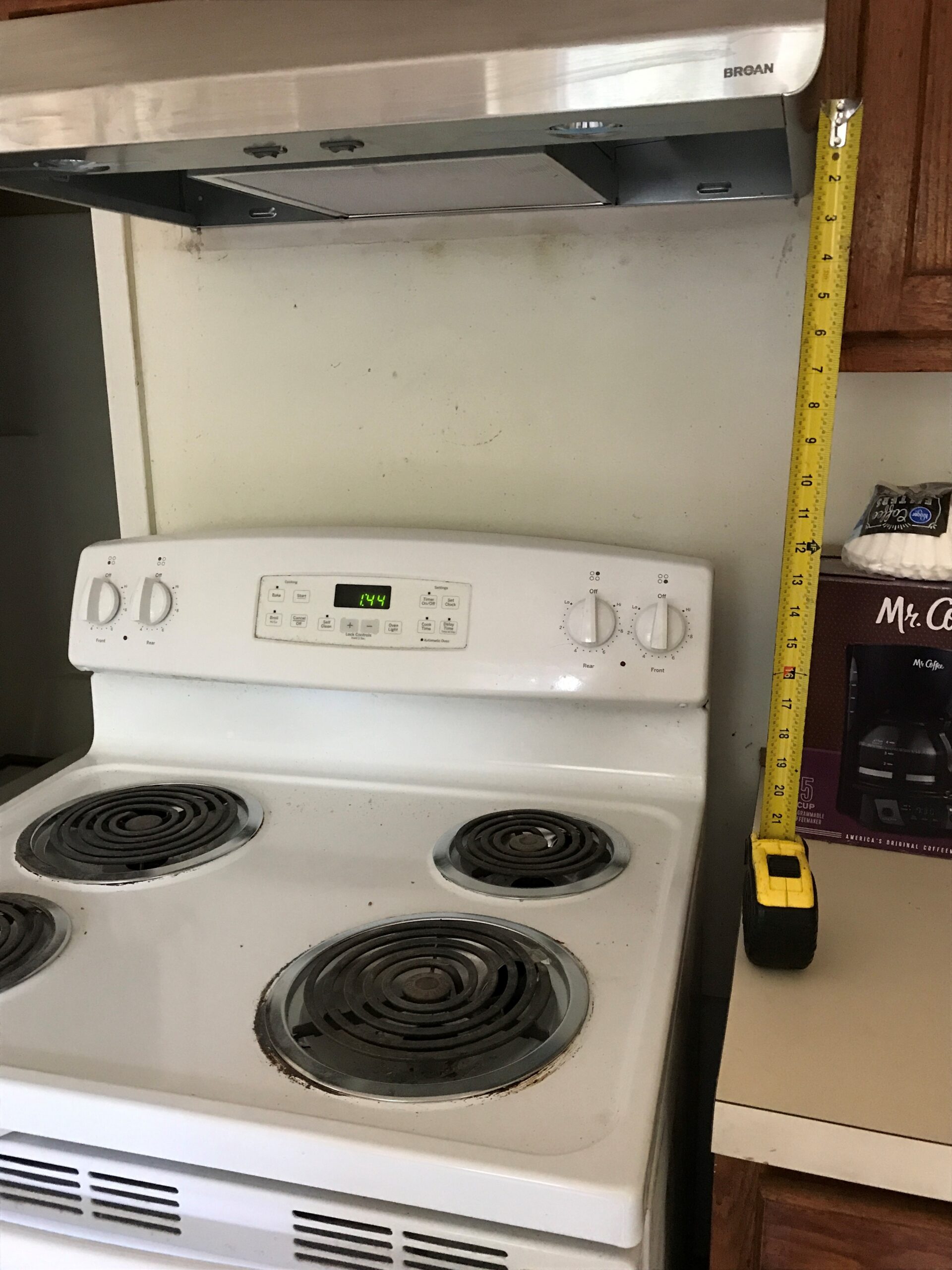 A measuring tape next to an electric stove