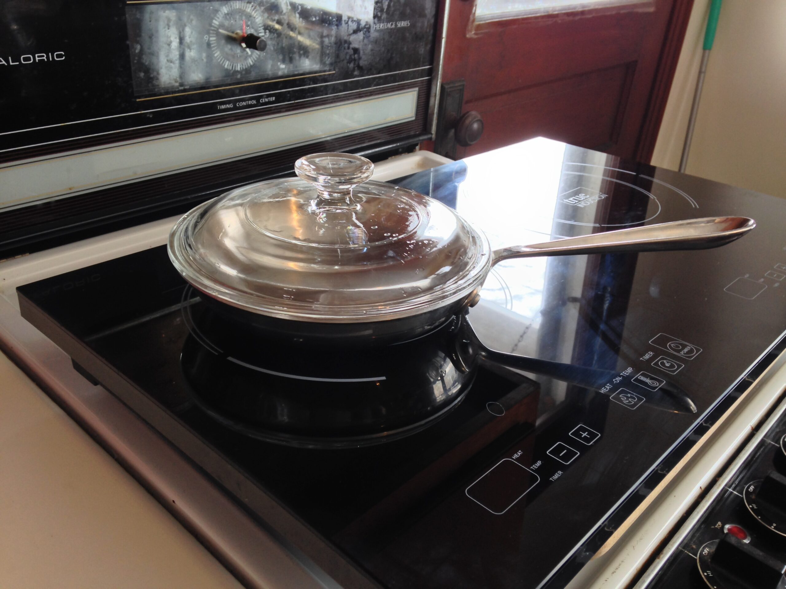 an induction stove top with pan