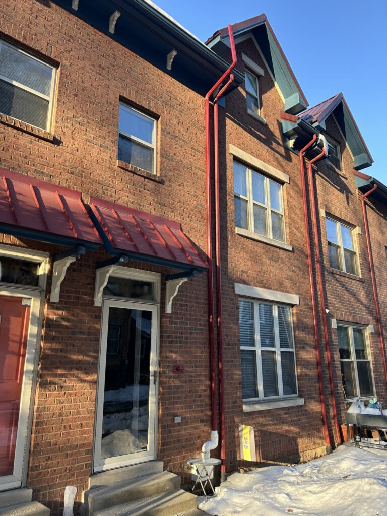 Completed metal radon pipe connection at upper soffit